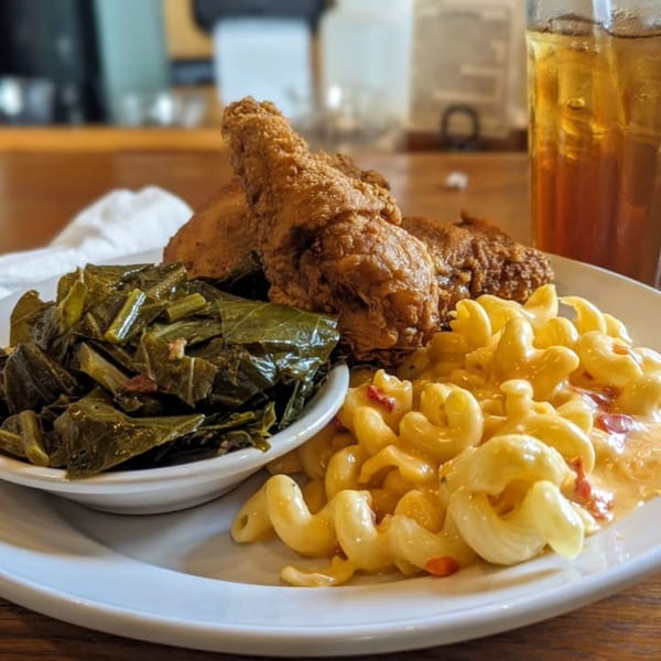 Southern Fresh fried chicken, collard greens, and macaroni and cheese with iced tea.