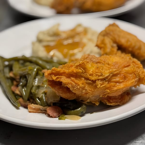 A Southern Fresh fried chicken plate with green beans, mashed potatoes, and gravy.